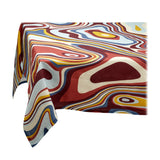 Linen rectangular tablecloth with an organic, psychedelic pattern in red, blue, yellow and ivory hues.