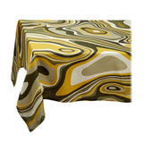 Linen rectangular tablecloth with an organic, psychedelic pattern in muted green, yellow, brown and ivory hues.