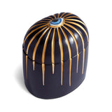 Dark blue cylinder candle with one wick posed with its eye motif topper