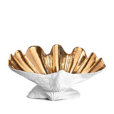 Neptune Bowl - X-Large. White porcelain shell-shaped bowl with gold interior floating on a base.