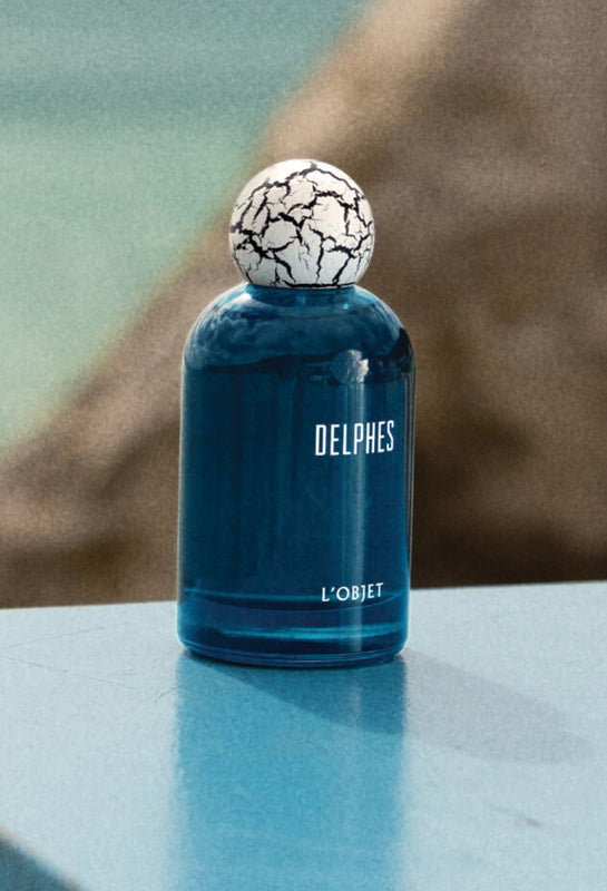 Blue Fragrance Bottle with White Crackle Top on Beach