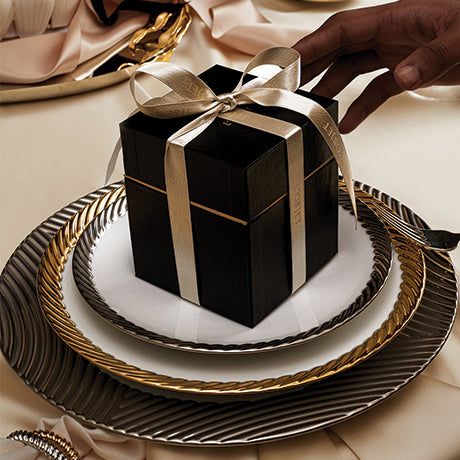 Black Box with White Ribbon on Fine Dinnerware and Lush Elegant Table Setting