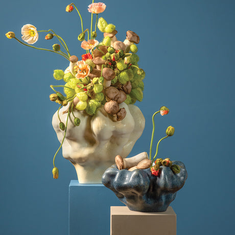 Decorative vases with floral arrangements on a blue background