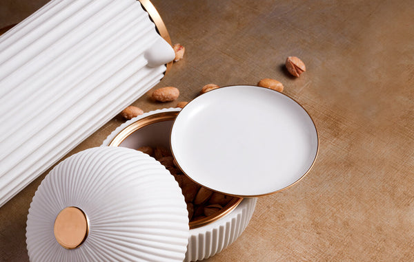 White porcelain plate box and french press with fluted design, gold details.