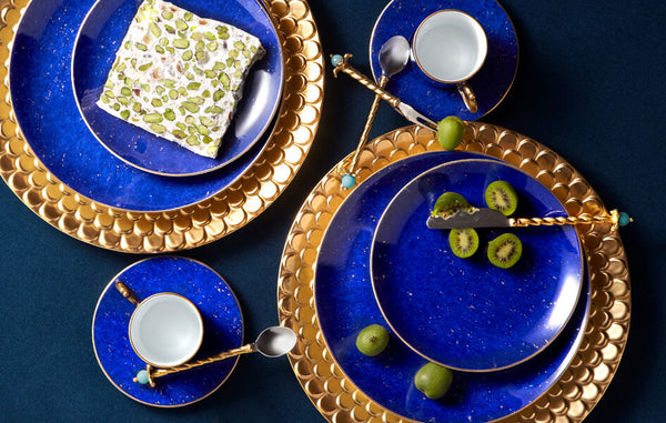 Tabletop set with porcelain Aegean gold charger plate with wave motif border, Lapis porcelain plates, tea cups and saucers.