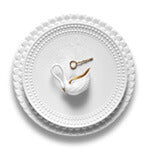 Aegean white charger plate with wave motif border, Perlee white porcelain dinner plate, white swan salt cellar.