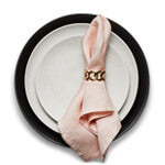 Iron and stone glazed Terra plate stack with pink napkin and gold Cuban Link napkin ring.