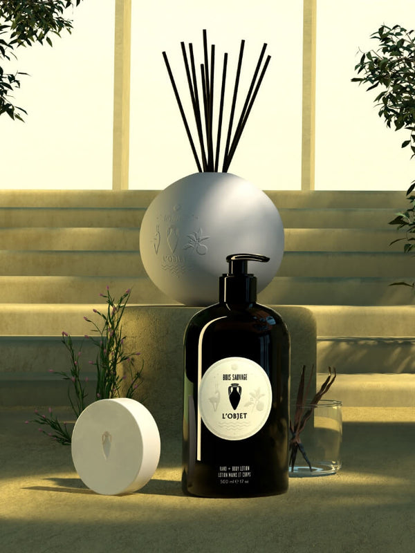 Decorative scene with bottles and a diffuser in an outdoor setting