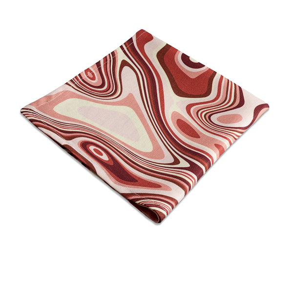Linen napkins with an organic, psychedelic pattern in red, pink, yellow, brown and ivory hues.