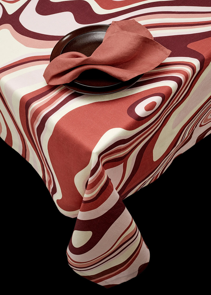Linen rectangular tablecloth with an organic, undulating pattern in red, pink and ivory hues.