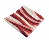 Linen napkins with an organic, undulating pattern in red, pink and ivory hues.