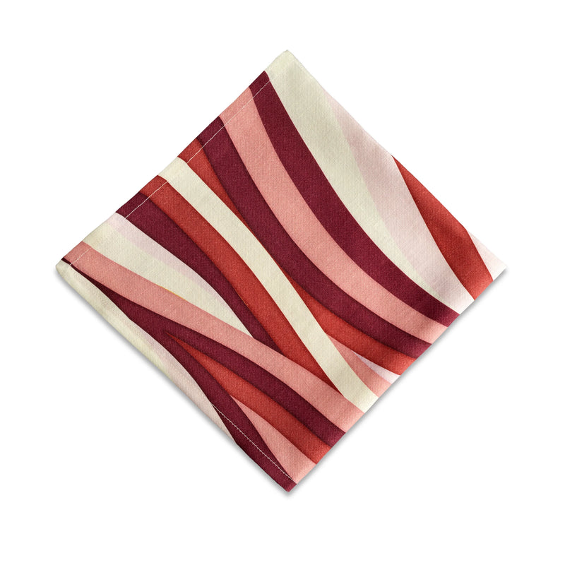Linen napkins with an organic, undulating pattern in red, pink and ivory hues.