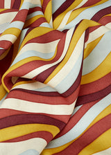 Linen rectangular tablecloth with an organic, undulating pattern in red, burgundy, blue, green and ivory hues.