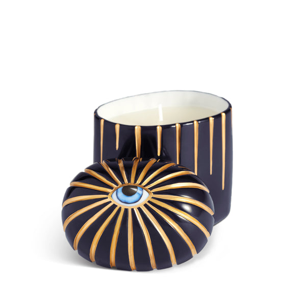 Dark blue cylinder candle with one wick posed with its eye motif topper
