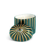 green cylinder candle with one wick posed with its eye motif topper
