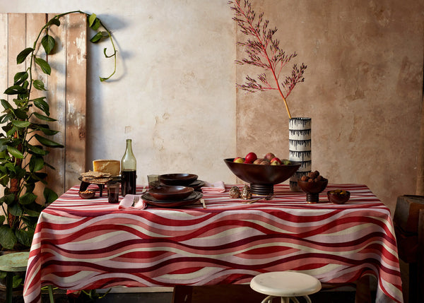 Tabletop set with linen sateen landscape tablecloth, Alhambra smoked wood bowl, and Tokasu porcelain vase with indigo drop motif