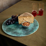 Oxidized green finish round placemat used as cheese plate