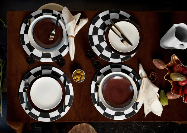 Tabletop with Damier placemats with black and white checkerboard pattern, Terra stone and iron dinnerware